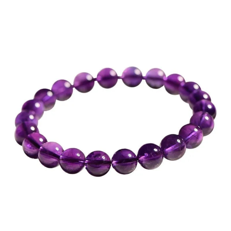Adjustable bracelet with scattered, polished natural amethyst beads from Uruguay on a wrist.