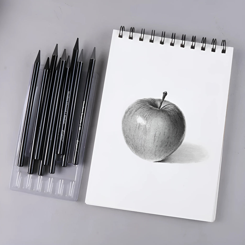 Set of six graphite and three carbonized pencils with wooden casings on a retail suction card.