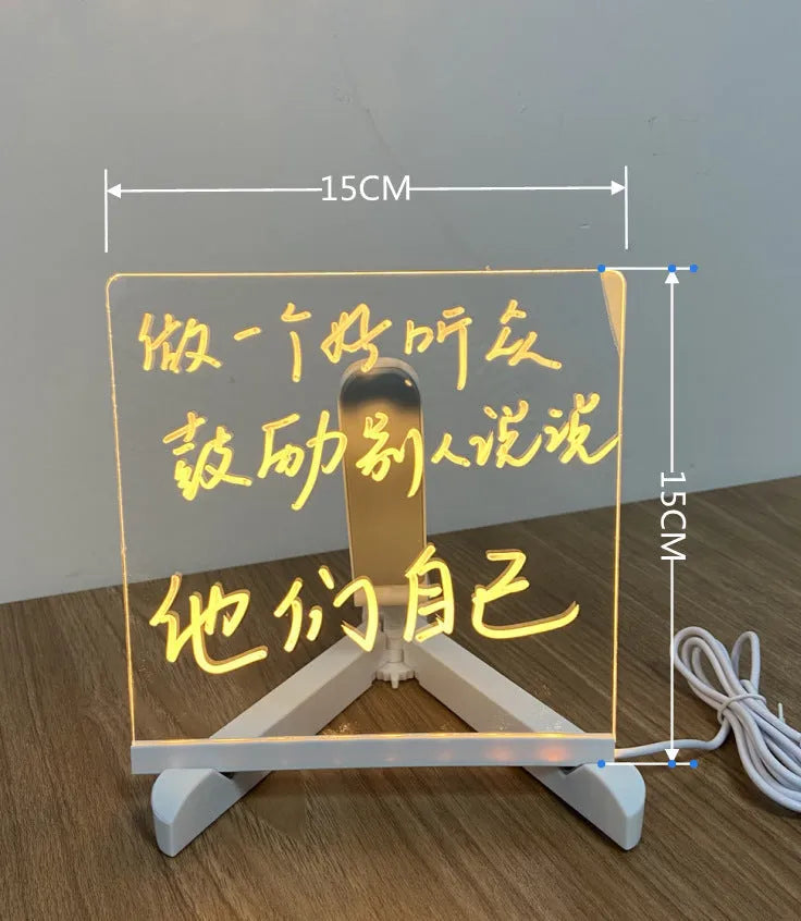 Acrylic LED message board night light on a desk with colourful handwritten notes glowing softly.