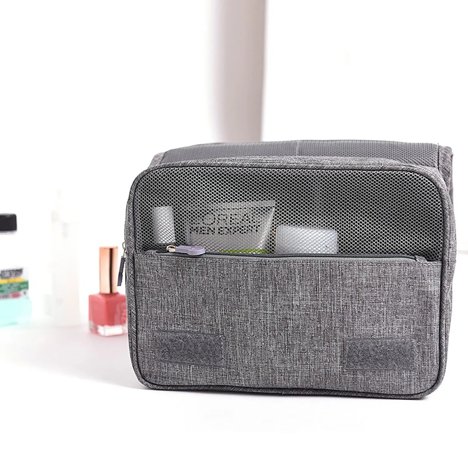 Large waterproof hanging toiletry bag in black with four compartments and metal hook