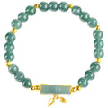 Simple sterling silver bracelet with a raised setting holding a natural blue jade round bead.
