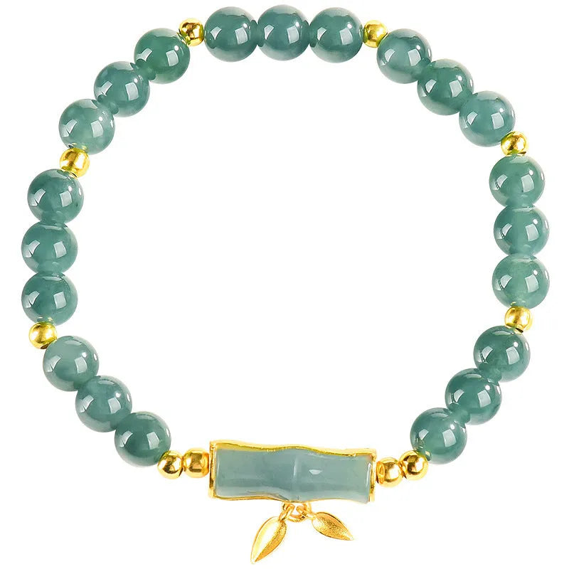 Simple sterling silver bracelet with a raised setting holding a natural blue jade round bead.