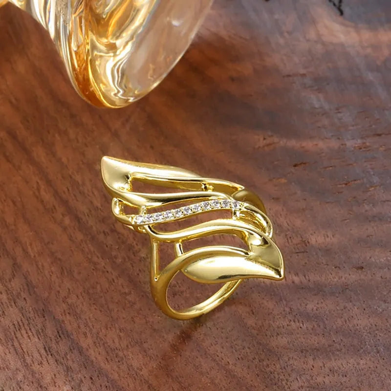 Women's copper ring with exaggerated curve design in Q611 gold colour showing side profile