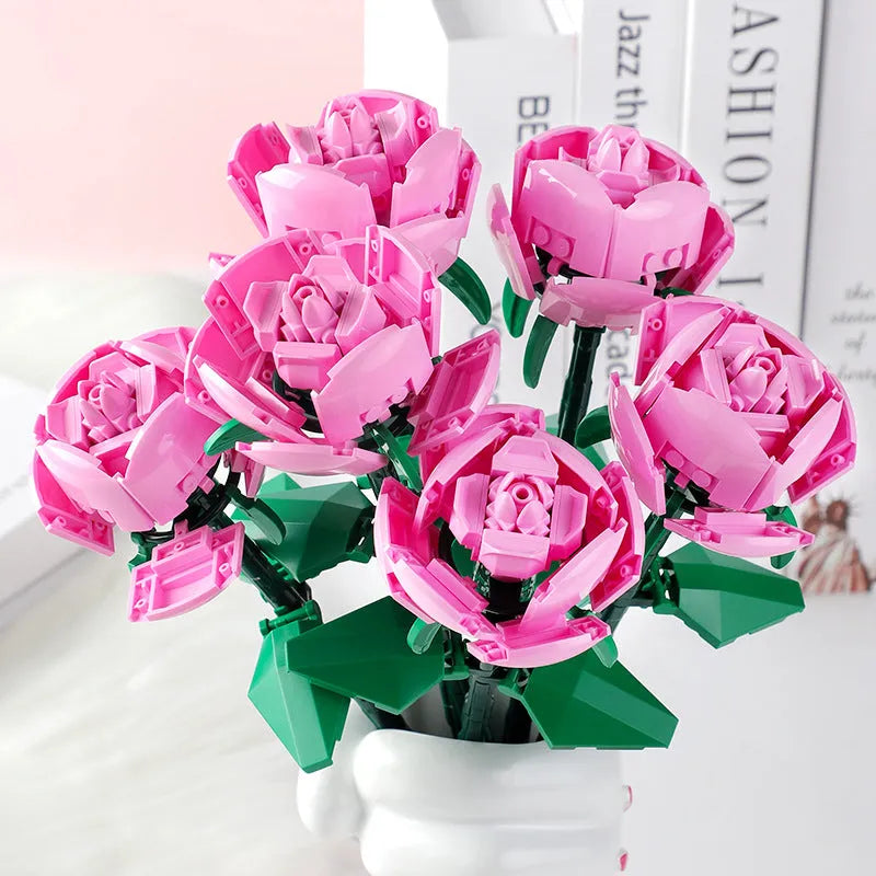 Rose assembled from small particle plastic building blocks in pink, red, or blue