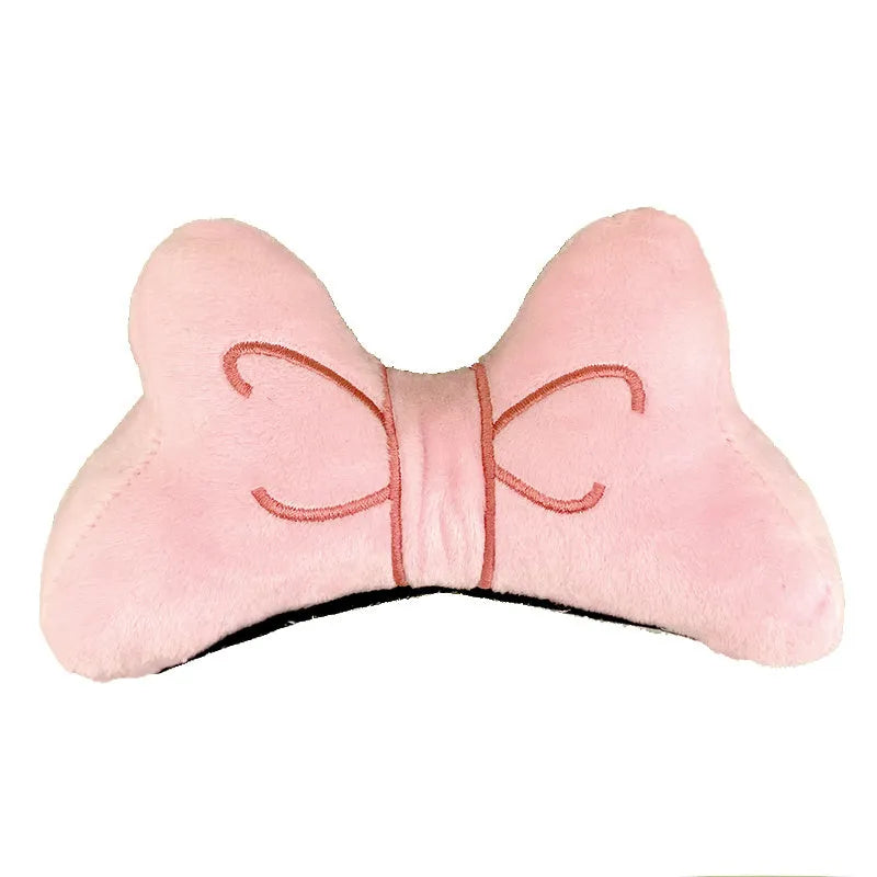 Soft plush decorative bow for clip-on attachment to a motorcycle or ski helmet.