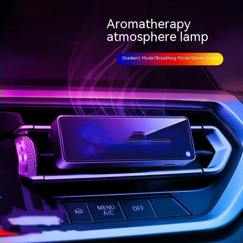 Black car air vent perfume diffuser with LED mood light mounted on vehicle ventilation louvre