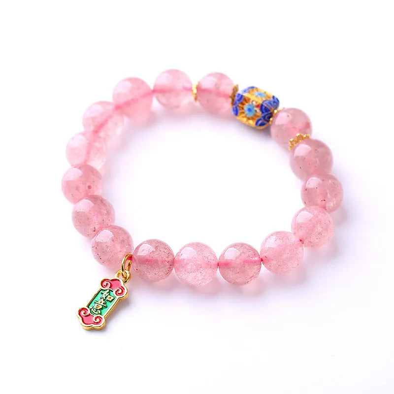 Pink strawberry quartz crystal bracelet with hand-woven construction and traditional Ruyi symbols