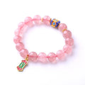 Pink strawberry quartz crystal bracelet with hand-woven construction and traditional Ruyi symbols