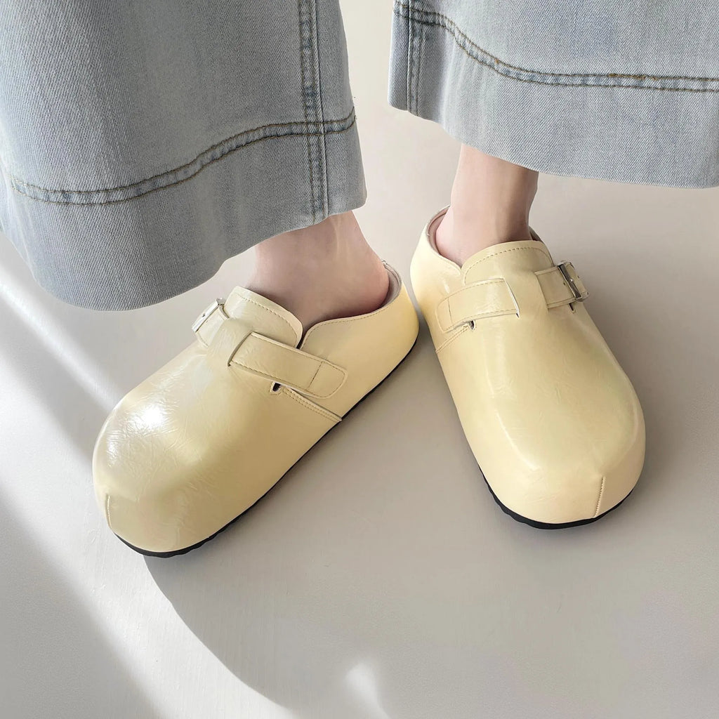 Flat buckle casual sneakers in yellow, creamy-white, silver, and black colours with round toe.