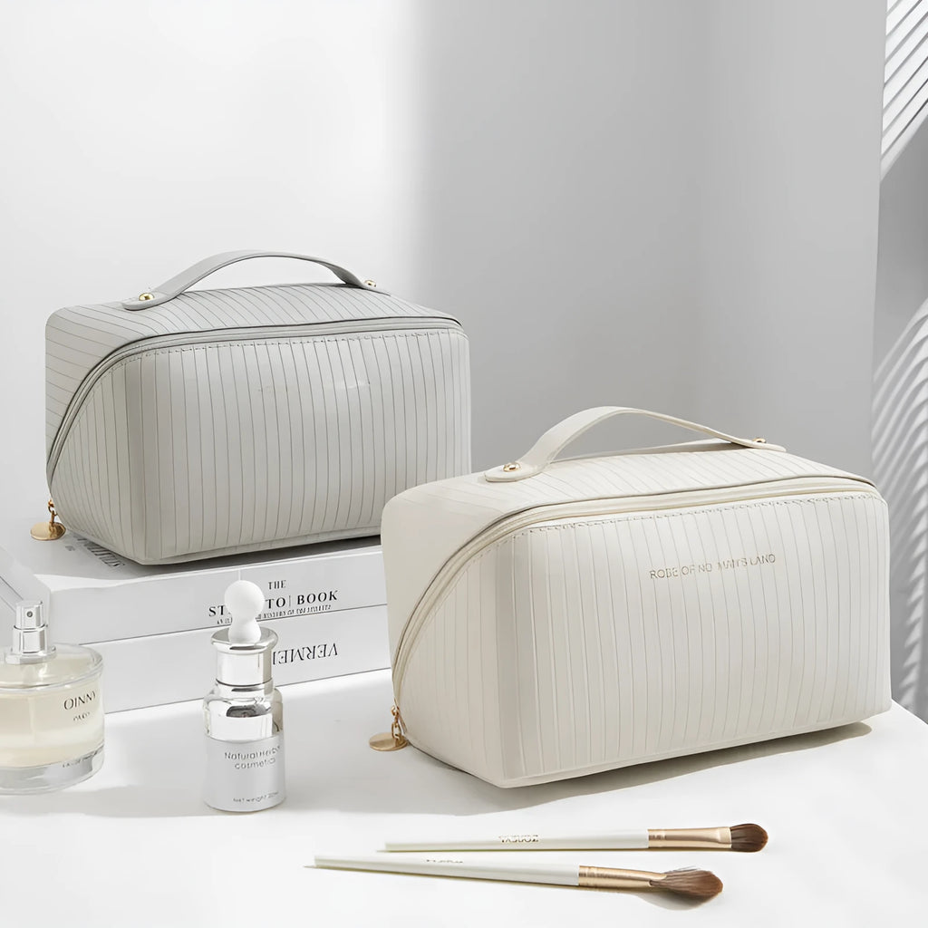 Vertical pattern pillow-shaped cubic makeup bag in PU material, shown in a neutral colour.