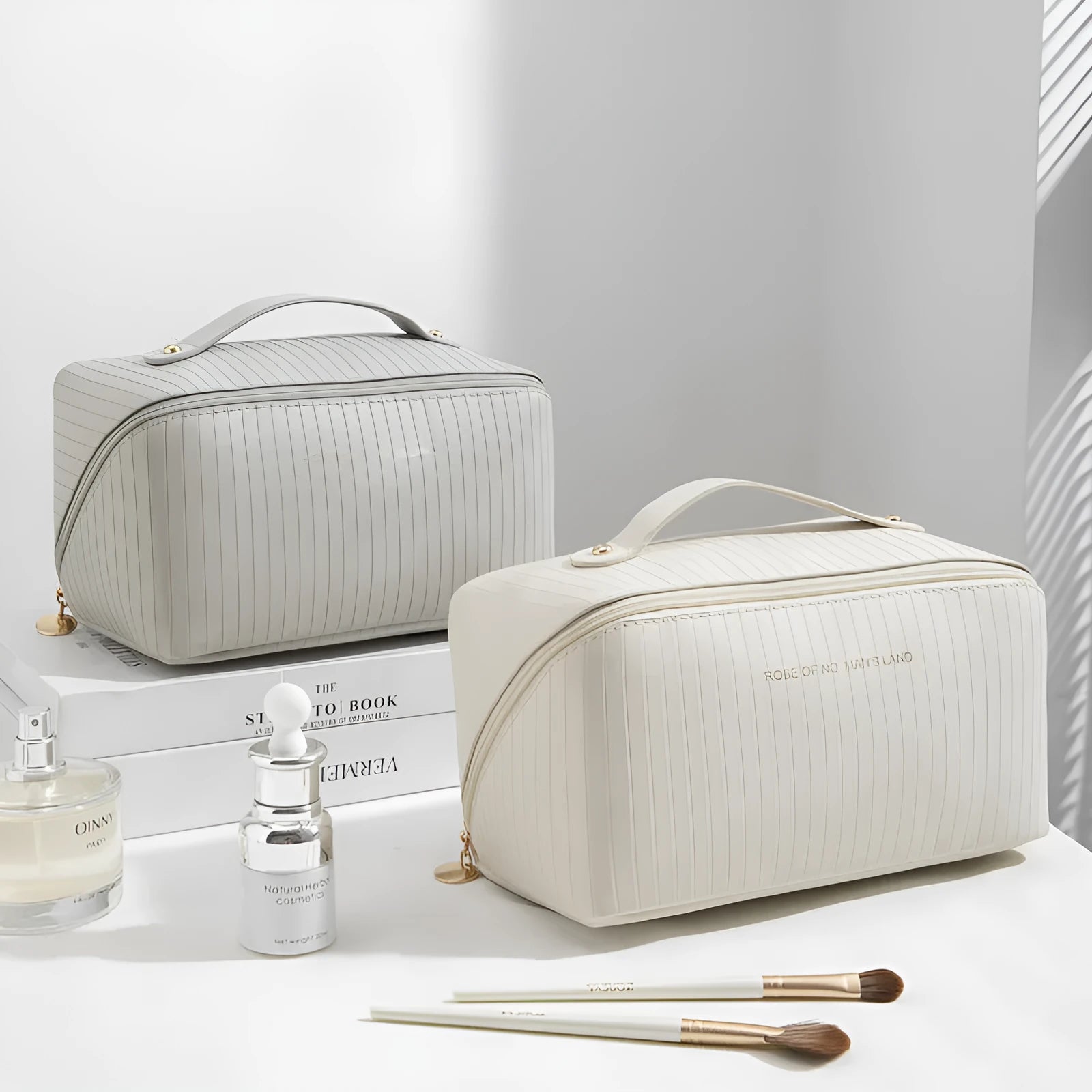 Vertical pattern pillow-shaped cubic makeup bag in PU material, shown in a neutral colour.