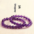 Adjustable bracelet with scattered, polished natural amethyst beads from Uruguay on a wrist.