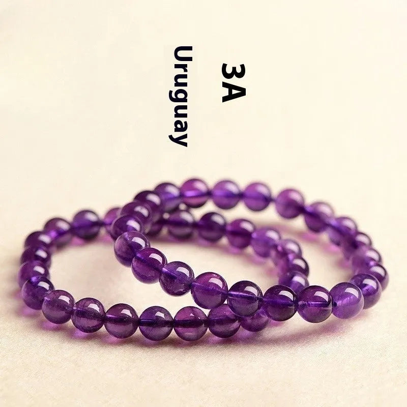 Adjustable bracelet with scattered, polished natural amethyst beads from Uruguay on a wrist.