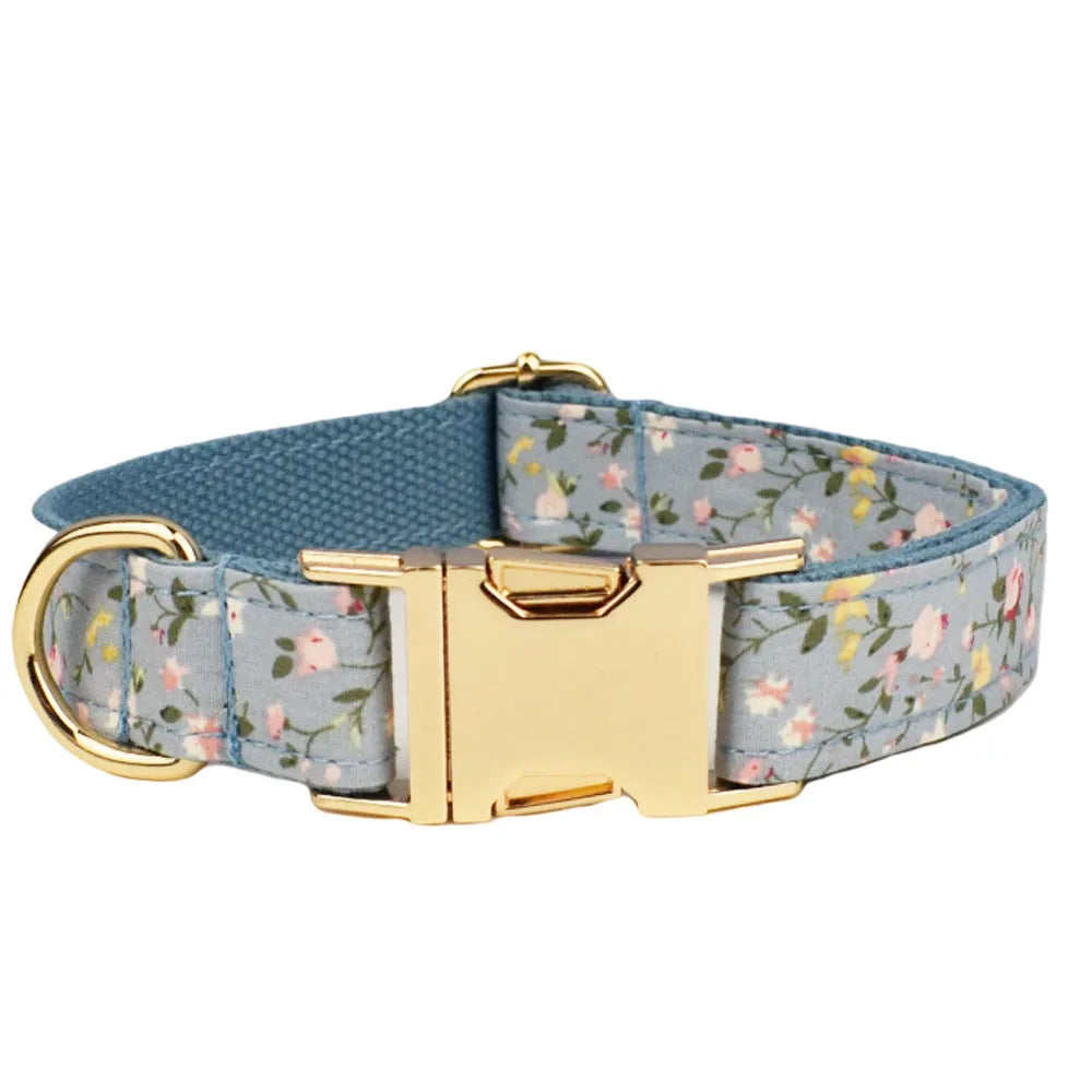 Blue floral dog collar and matching leash, bow, vest, and waste bag holder five-piece pet set.
