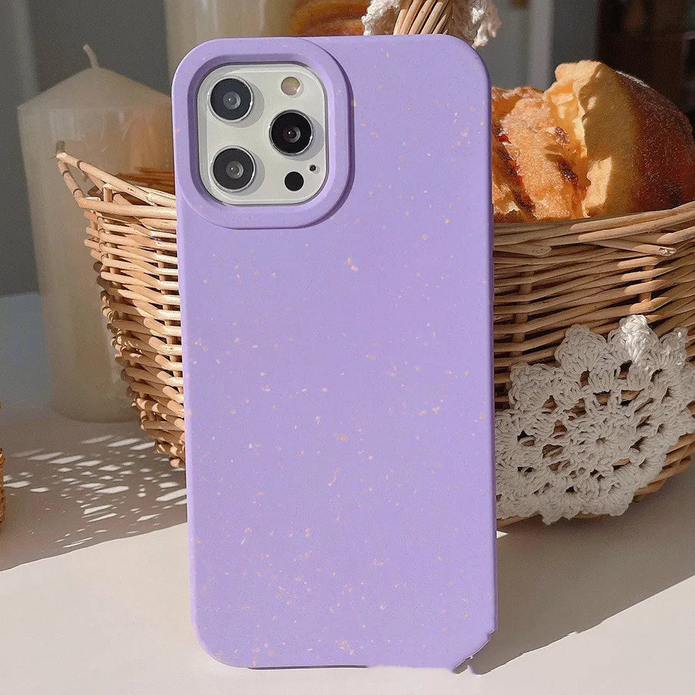 A degradable wheat straw phone case for iPhone on a wooden surface, showing its rear cover design.
