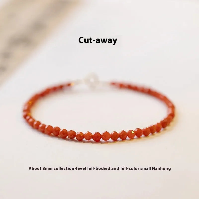 Women's retro-style bracelet with natural southern red agate stones in red colours on a white background.