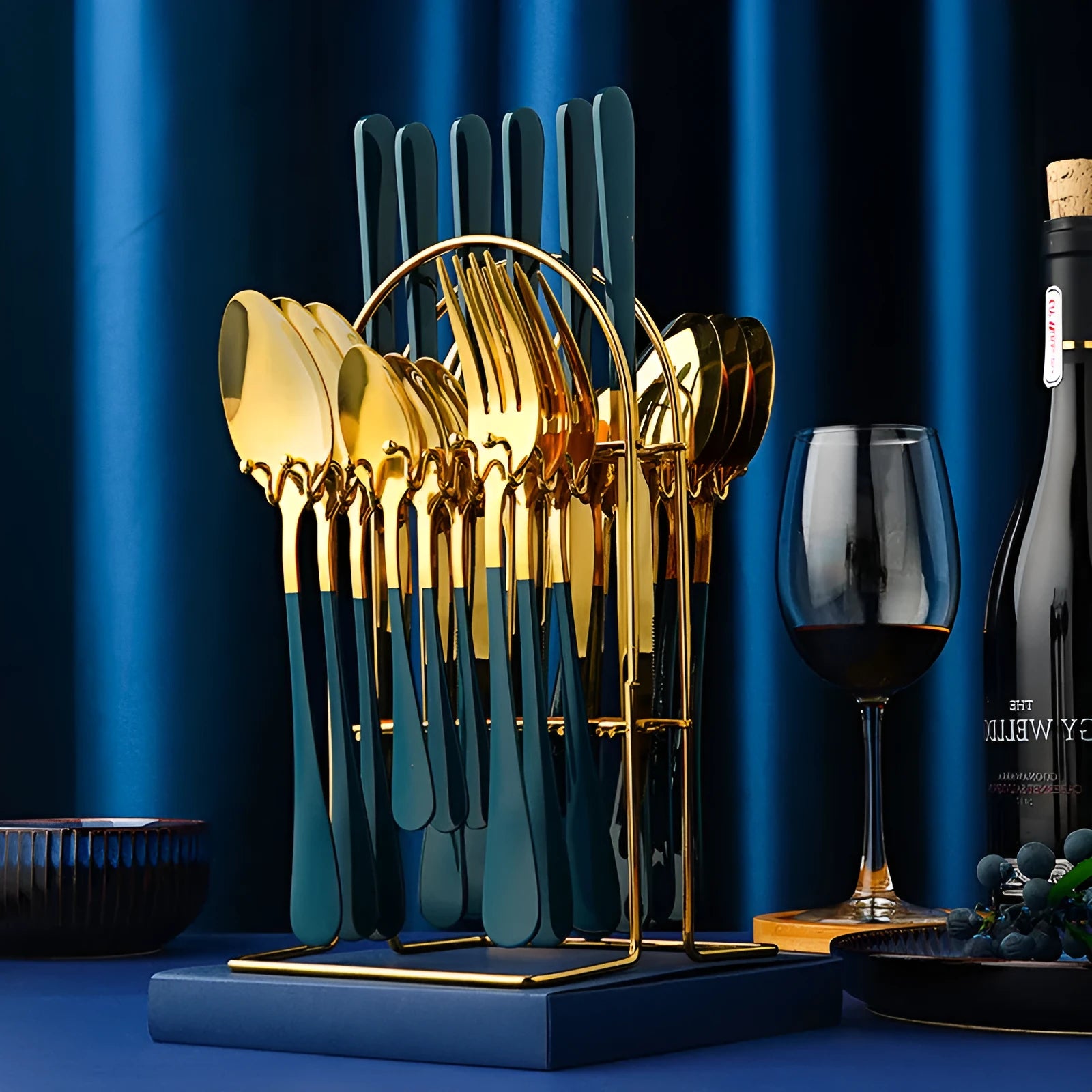 Gold stainless steel 24-piece cutlery set with knives, forks, spoons, tea spoons and a storage rack.