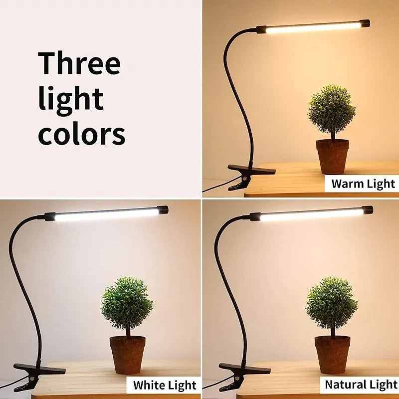 Black and white USB-powered LED desk lamp with a 26 cm long base on a wooden desk.