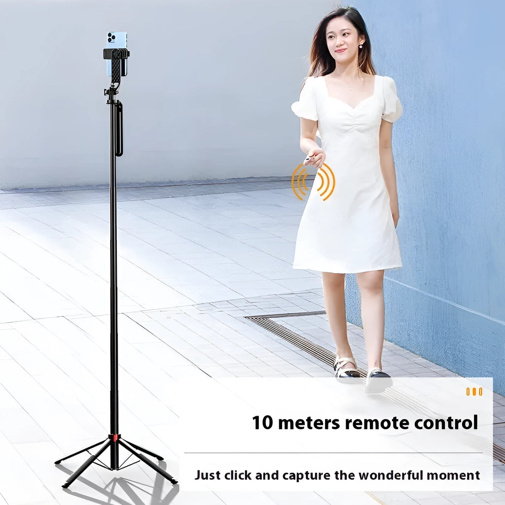 Bluetooth quadrupod selfie stick tripod with remote control, phone clamp, and four legs extended on a table