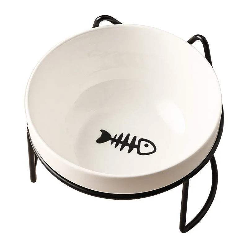 White ceramic cat bowl with cat footprint design on a black iron stand with cat ears.