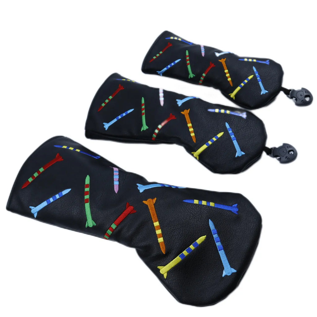 Set of three wooden golf practice clubs in black, showing large, medium, and small sizes on grass.