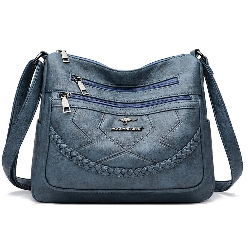Soft leather crossbody shoulder bag in horizontal square design with zippered internal pocket