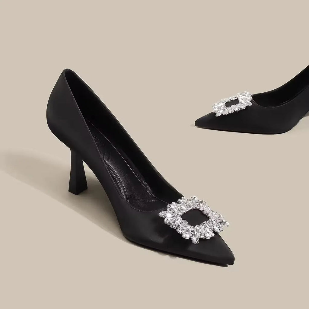 Women's creamy-white pointed toe stiletto high heel pumps for formal wear.