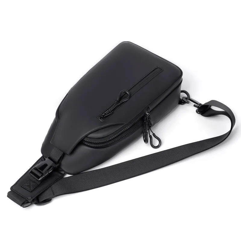 Black sling crossbody backpack for men with zip closure and soft handle, solid colour