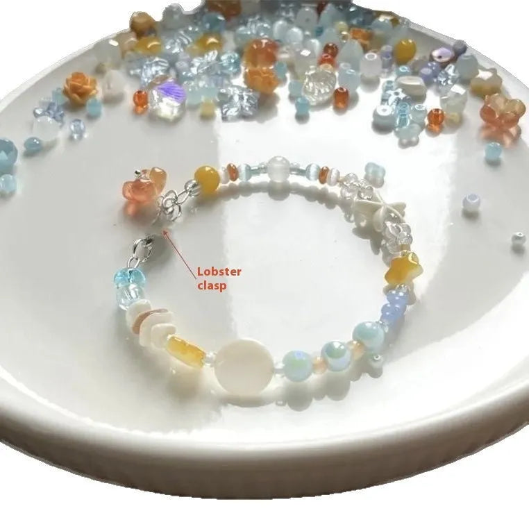 Women's orange summer bracelet with a diamond-shaped alloy centrepiece on a mixed-material band.