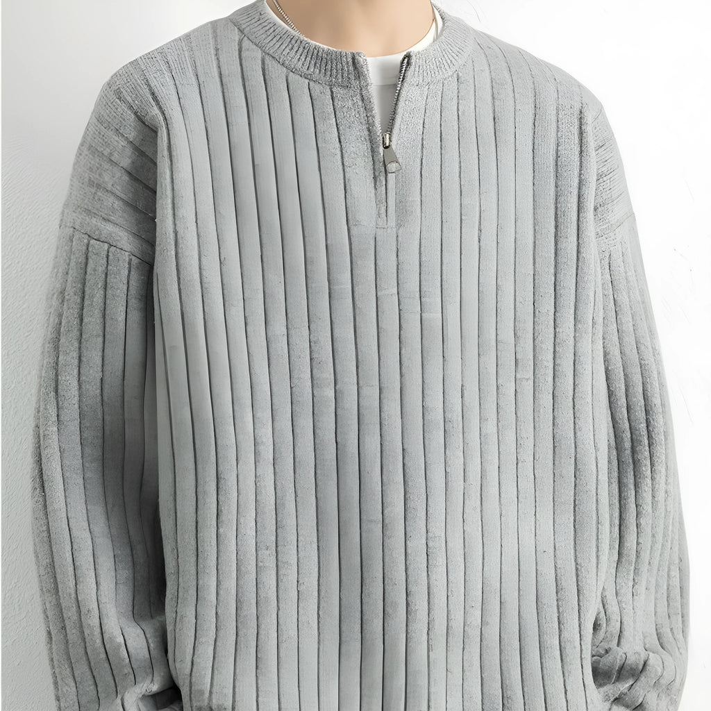 Men's grey half-zip loose knit sweater with textured fabric and long sleeves.