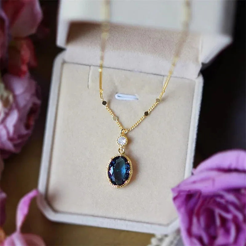 Gold geometric pendant necklace with a French retro design on a model.