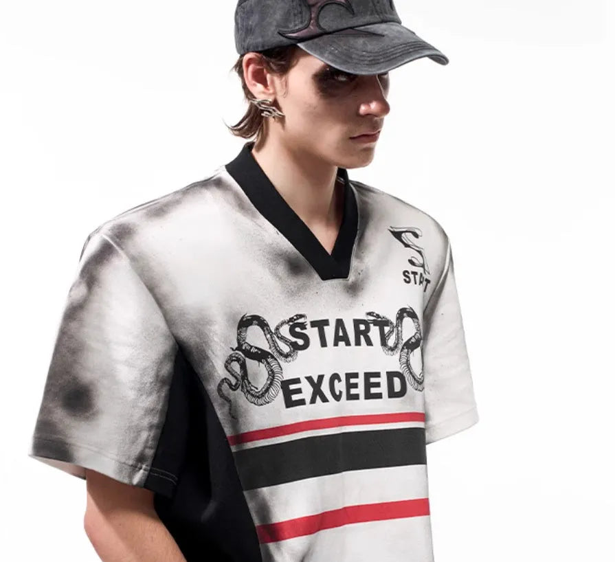 V-neck short sleeve top with snake letter pattern print and padded shoulders.