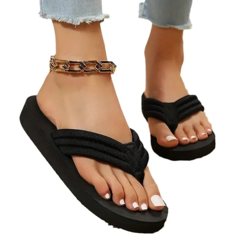 Black women's cotton flip-flop slippers with a ribbon detail on a flat EVA sole.