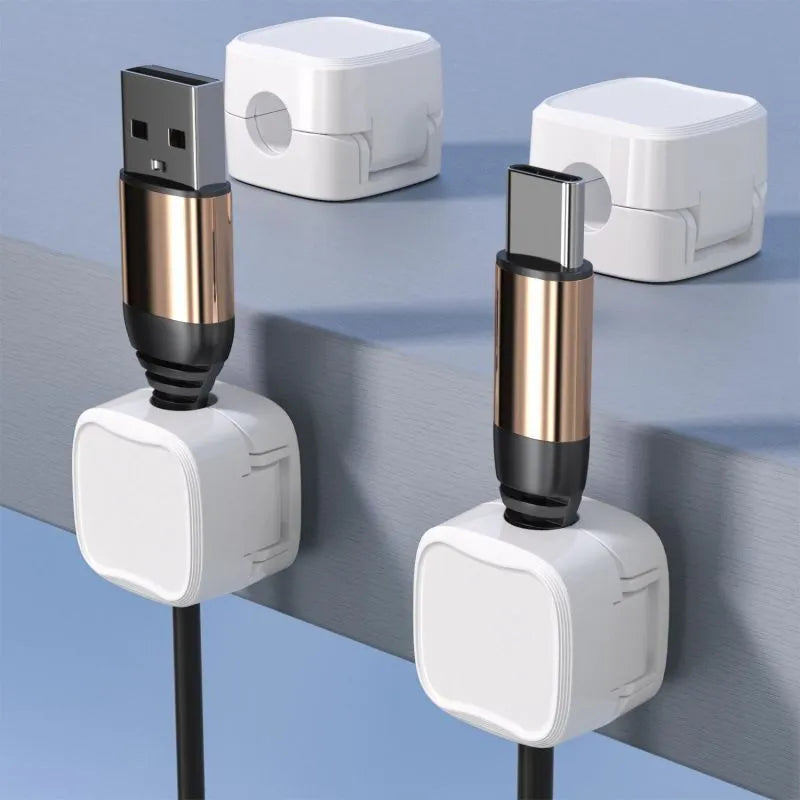 Black and white magnetic cable clips with adhesive backing for under desk cable management.