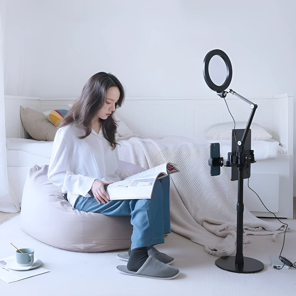Black aluminium alloy floor standing mobile tablet holder with integrated LED fill light in folded position