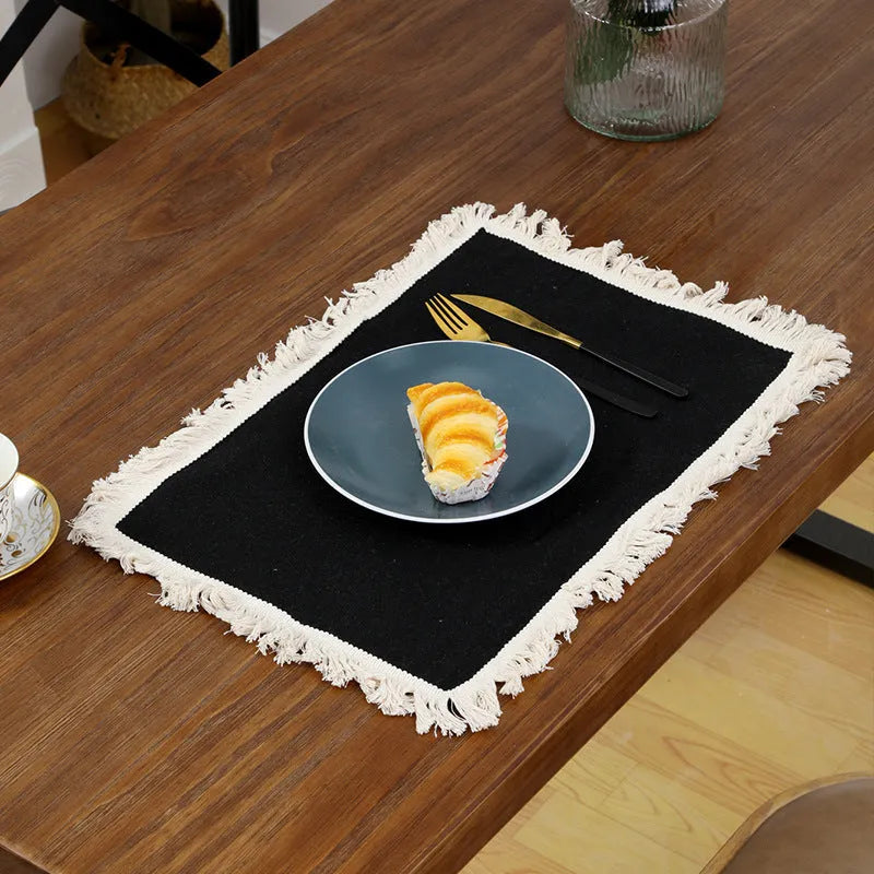 Solid colour square polyester placemat on table in beige colour