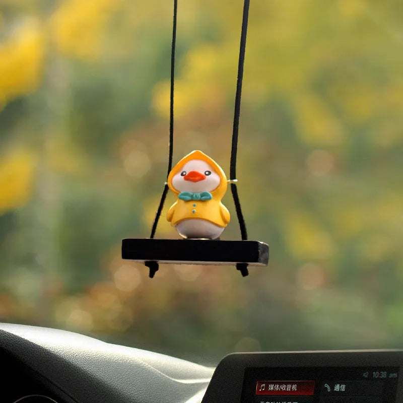 Cute yellow plastic duck doll car hanging ornament in a cartoon style.