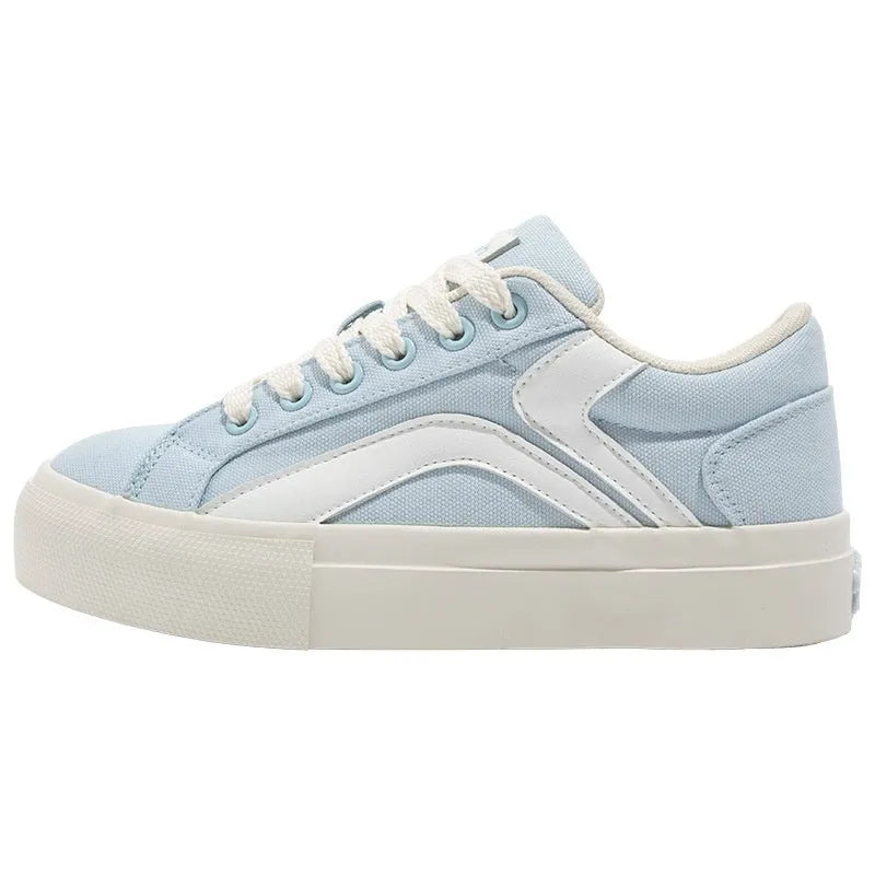 Women's blue and white low-top board shoes with vulcanised rubber soles and lace-up front.