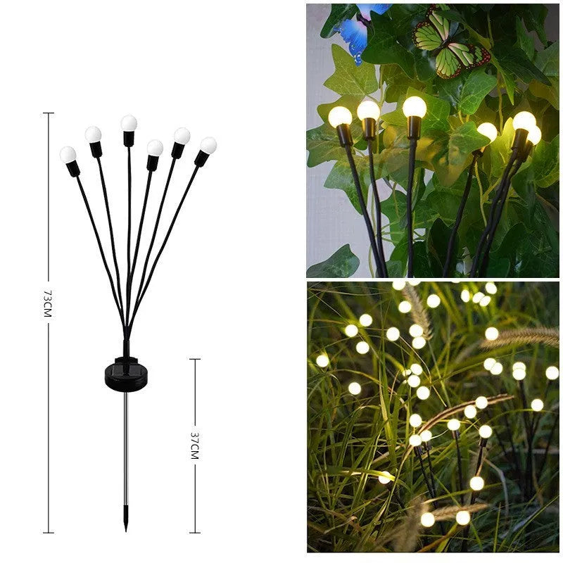 Solar-powered LED garden spike light with multiple glowing heads and a metal ground plug inserted in soil at dusk.