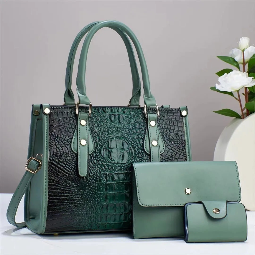 Women's burgundy textured PU leather three-piece set showing bucket crossbody bag, matching wallet, and card holder.
