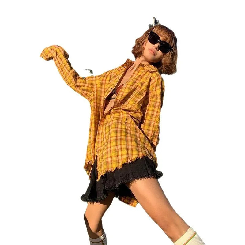 A man and woman wearing a loose-fit dopamine yellow plaid shirt in a cardigan style.
