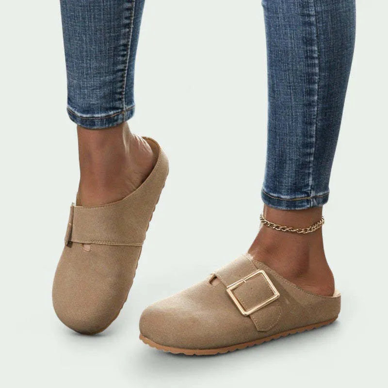 Women's brown closed toe canvas slippers with low top design showing pull-on style and textured canvas upper