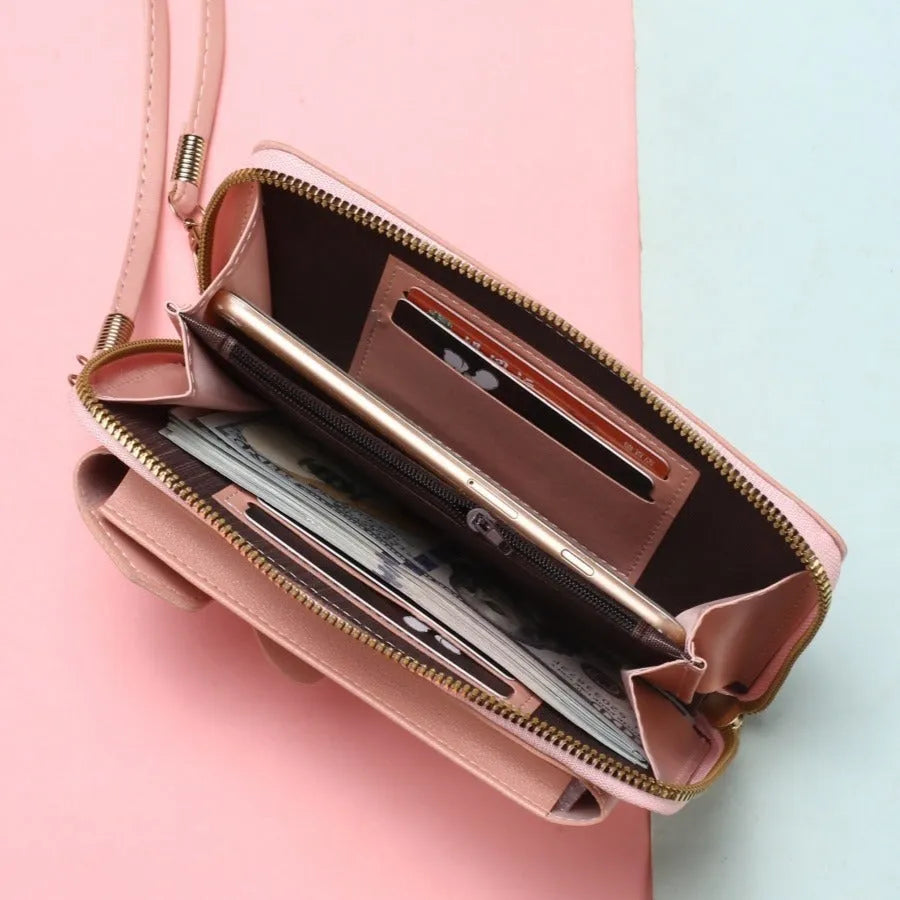 Mini crossbody phone bag for women in black PU leather with adjustable strap and sewing thread detail.