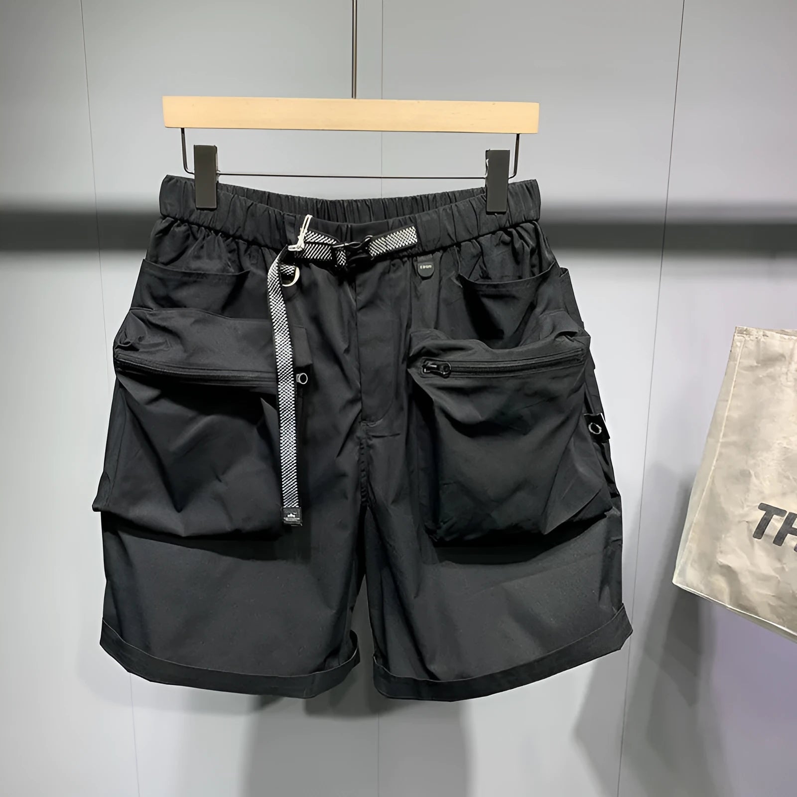 Large size men's work shorts in black with multiple pockets and straight leg design