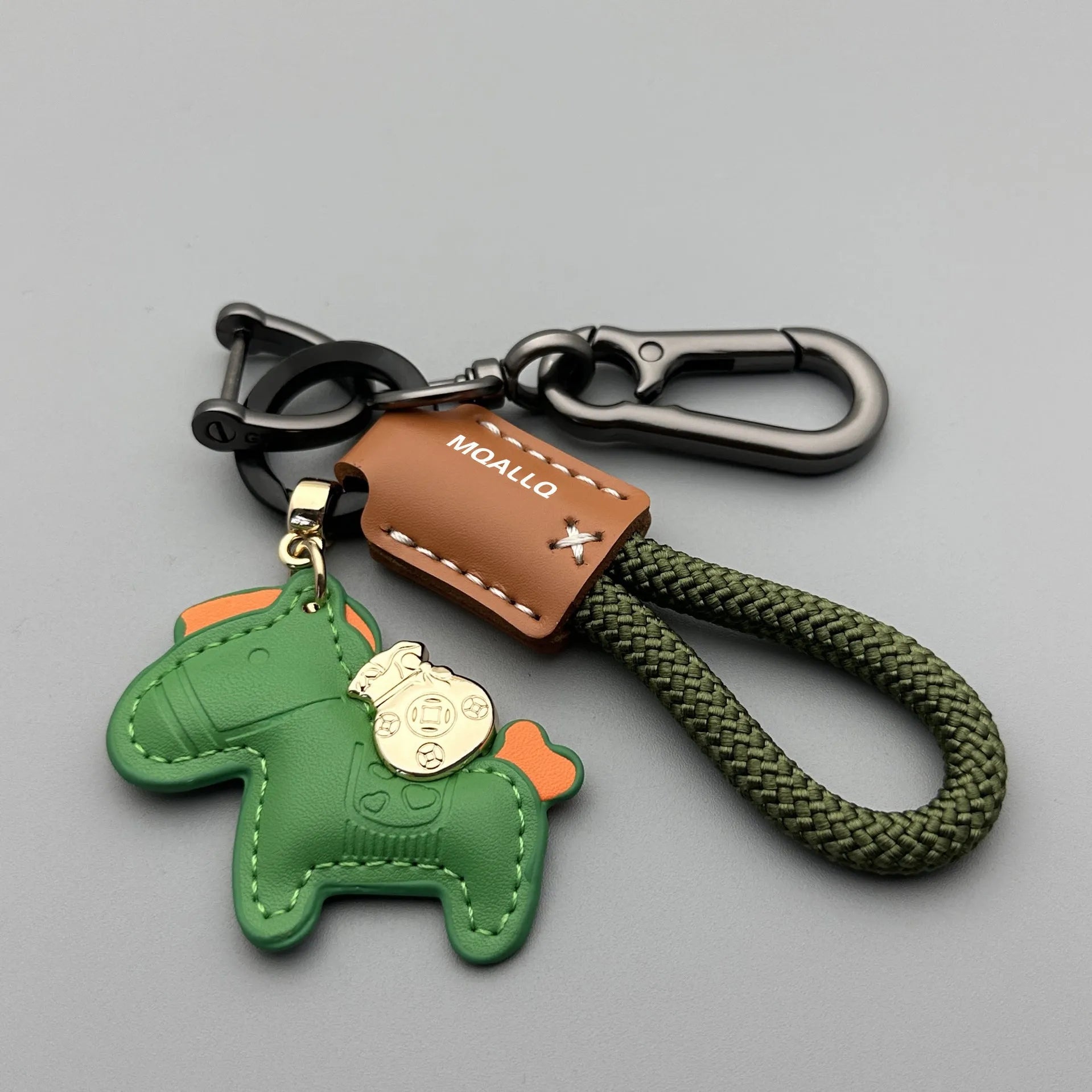Handmade brown cowhide leather keychain with a silver pony belt buckle charm and green velvet rope.