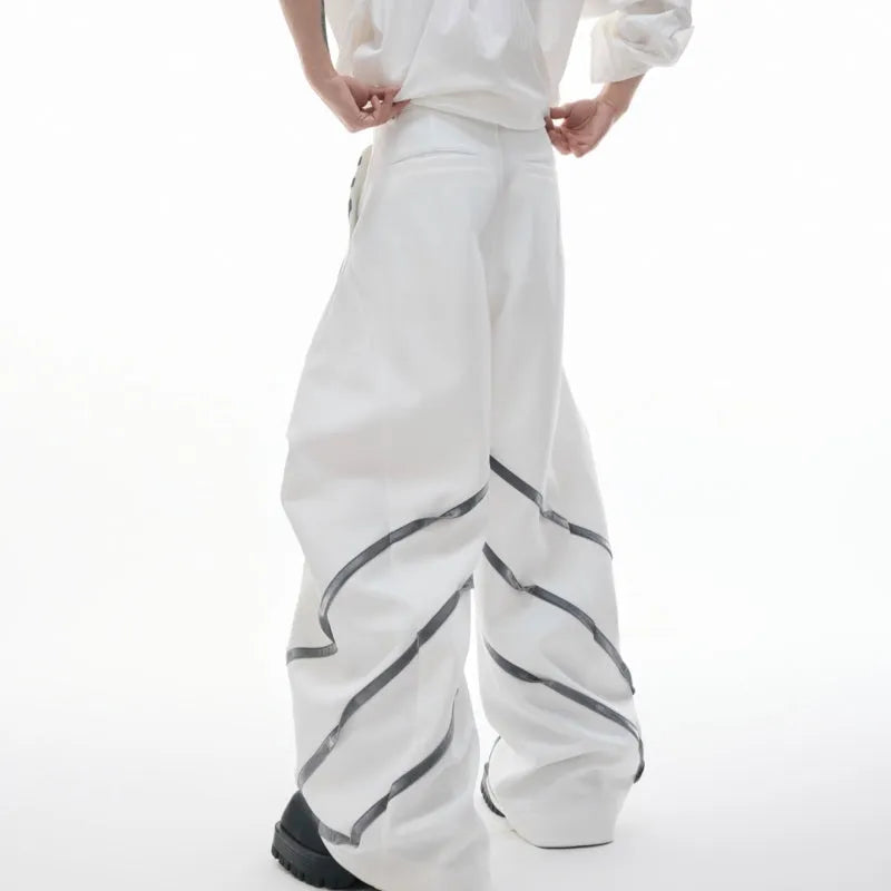 Men's black trousers with metal striped rivet and pleated detail on a three-dimensional cut.