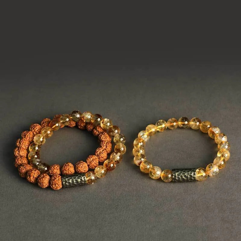 Handmade yellow tower crystal bracelet with double ring design on wrist.