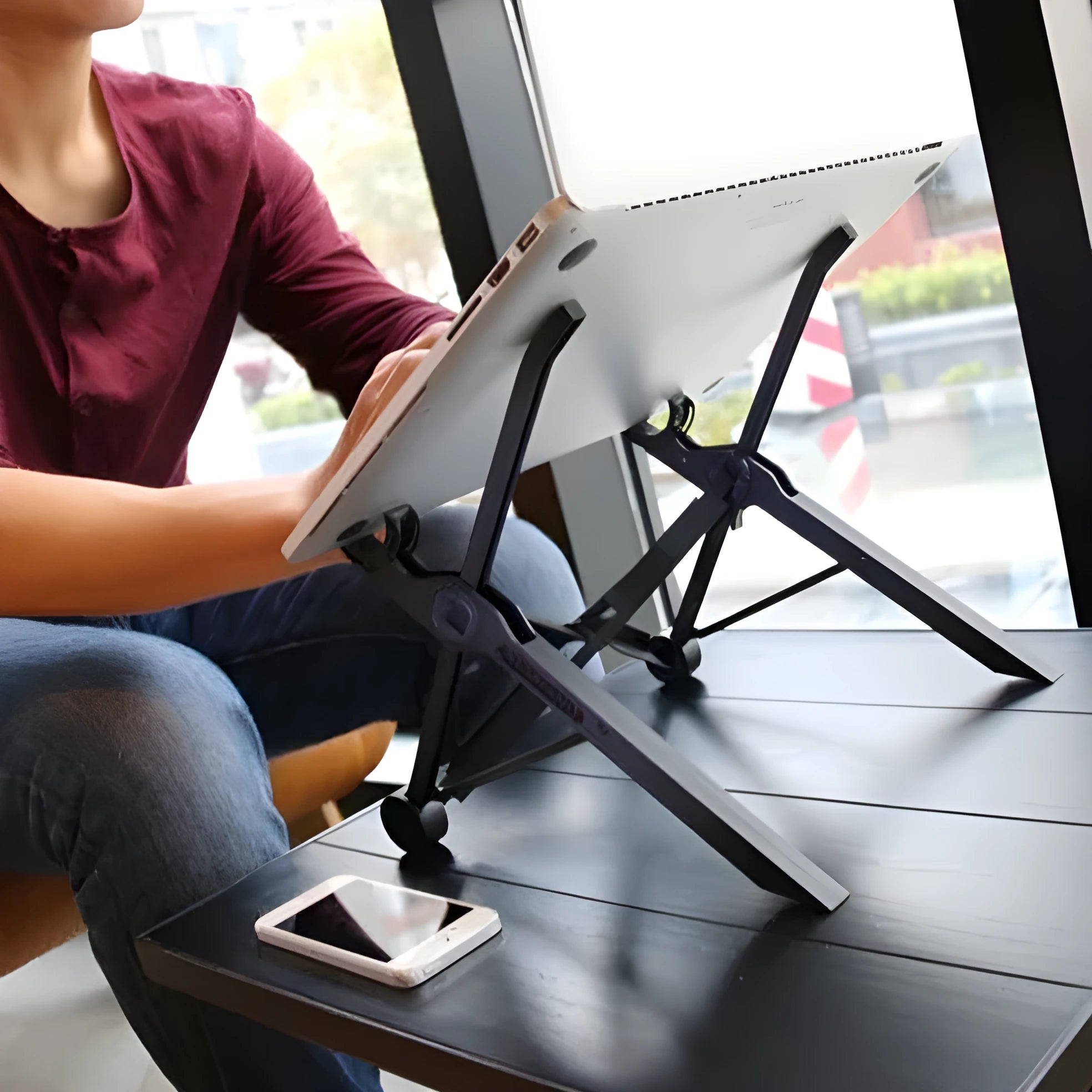 Sagacious black folding computer bracket with carrying case, shown in deployed and folded positions