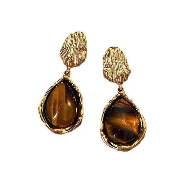Three pairs of geometric earrings with tassel detailing in different styles: round, irregular, and water drop shapes.