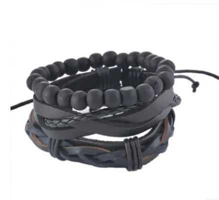 Handmade brown leather wrap bracelet with wooden beads and braided cord on a wrist.